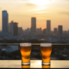 Krysar In The Foreground Is Table At Rooftop Bar With Two Sweat 63f09ba0 7443 486f 8357 82f89c951b09
